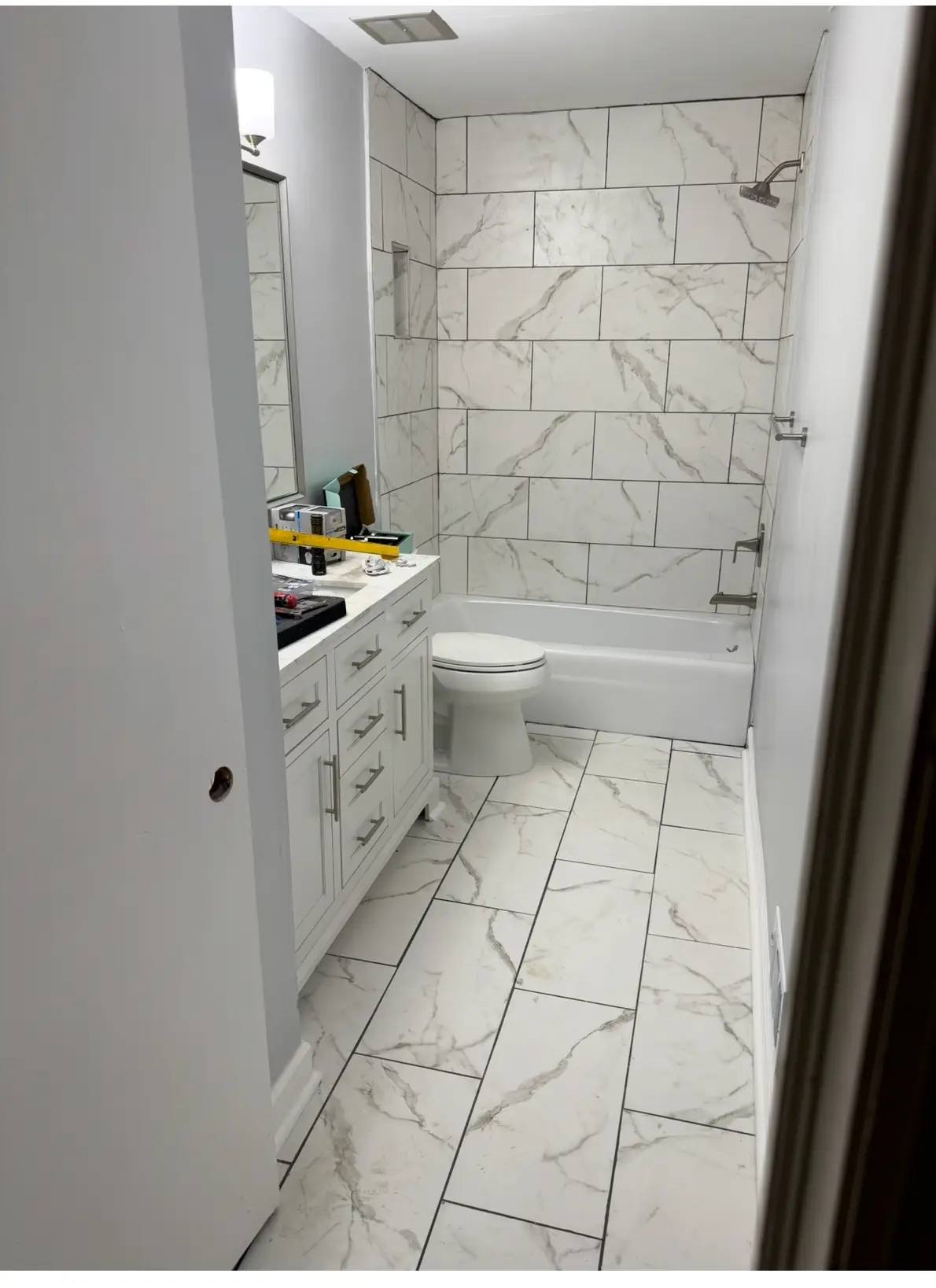 Completed bathroom renovation with rebuilt floor and new tile