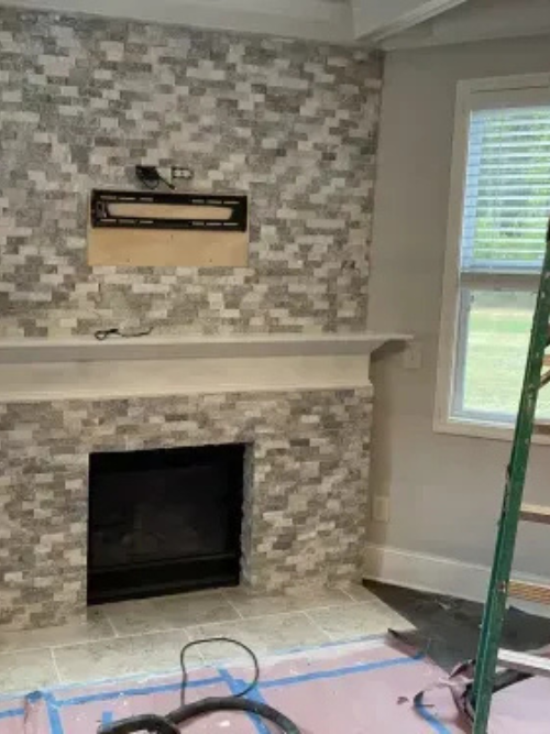 Living room fireplace renovation with modern tile surround