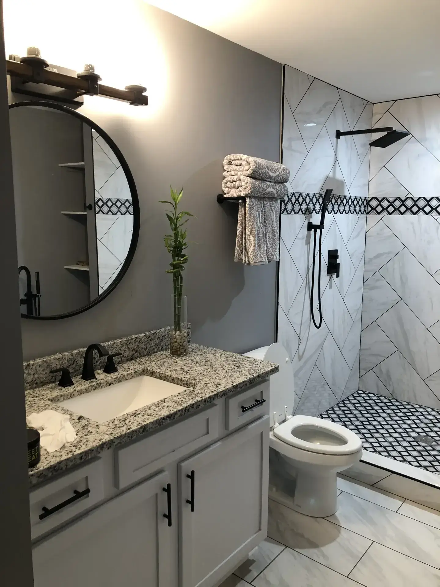 Finished basement bathroom with custom tile shower and vanity